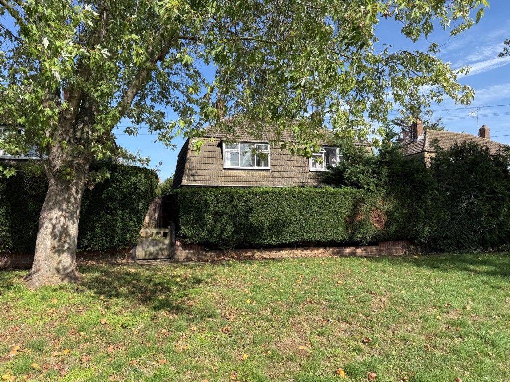 Lot: 164 - TWO-BEDROOM SEMI-DETACHED HOUSE FOR IMPROVEMENT AND REPAIR - Front of the house taken from the greensward
